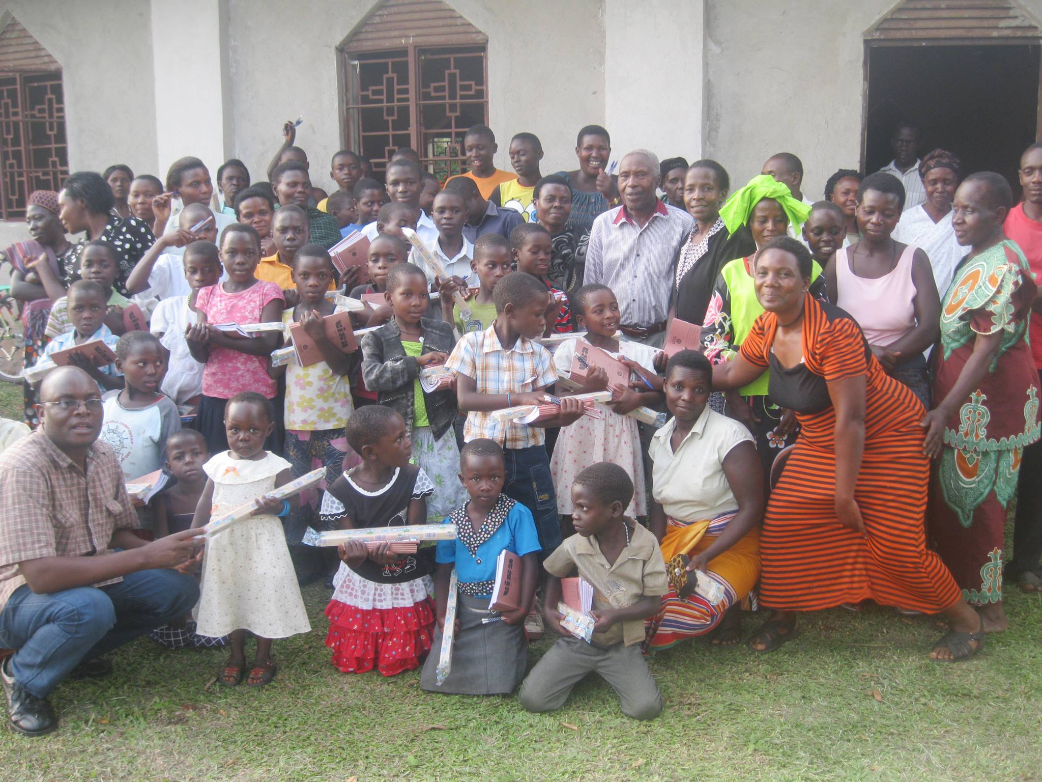 Ainganiza (Lt)_ Grace Kasabiiti (Rt) and Sponsored Children Recieve Scholarstic Materials. Your kind support makes a big change in their lives.