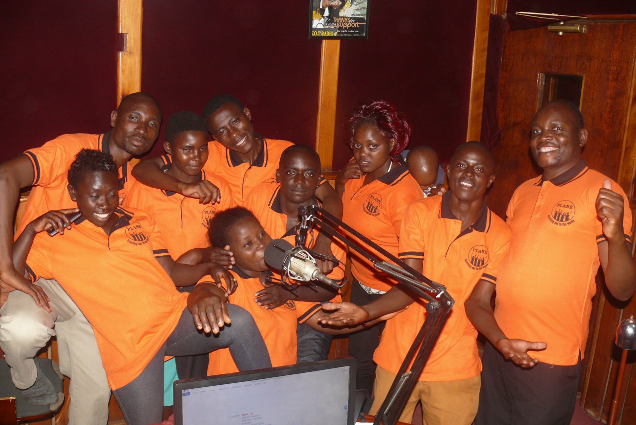 Ainganiza Steven (RIGHT) smelling _ his Radio drama crew